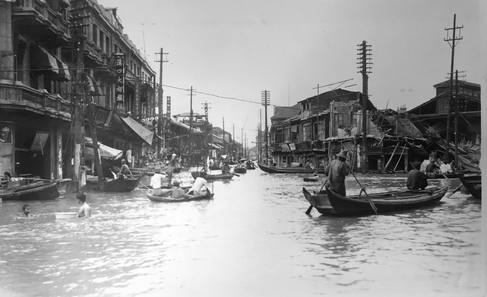 Survivors navigating floodwaters in makeshift rafts in 1931 