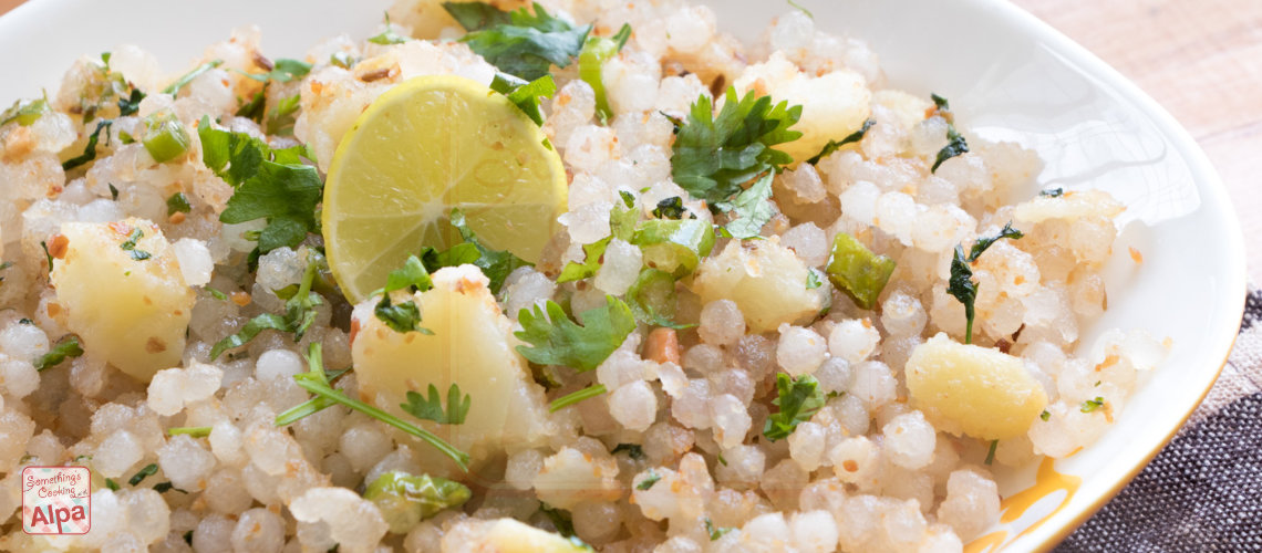 A plate of Sabudana Khichdi garnished with coriander and lemon